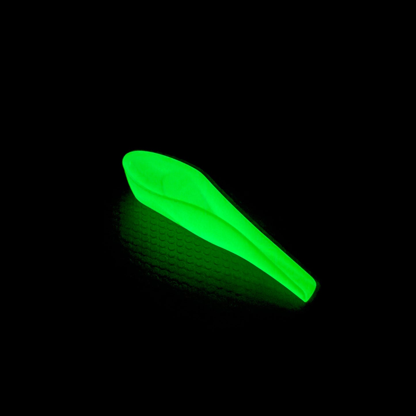 Glow-in-the-dark pStyle - personal urination device - glowing on a black background
