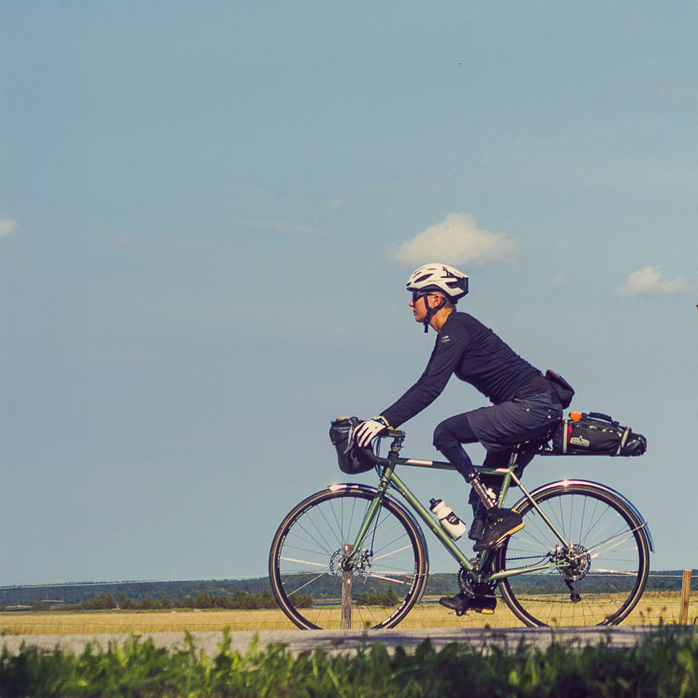 A person with double-amputee legs riding a bicycle. 